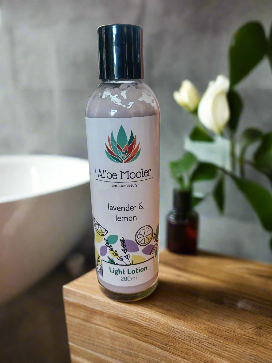 A bottle of Aloe Mooler lavender and lemon light lotion on a marble surface with a blurred background.